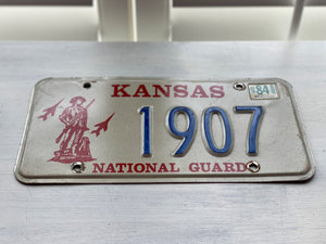 VINTAGE LICENSE PLATE:  1984 KANSAS (STICKER)--RARE/SPECIAL RED, BLUE, AND CREAM NATIONAL GUARD PLATE