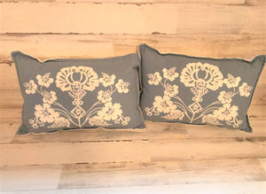CHAMBRAY-BLUE, LUMBAR-STYLE PILLOW WITH CREAM-COLORED FLORAL EMBROIDERY