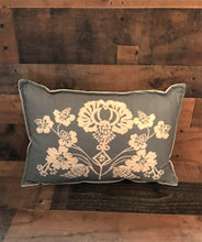 CHAMBRAY-BLUE, LUMBAR-STYLE PILLOW WITH CREAM-COLORED FLORAL EMBROIDERY